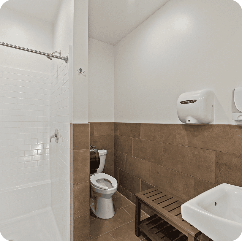 Clean bathroom with brown tiles and sink