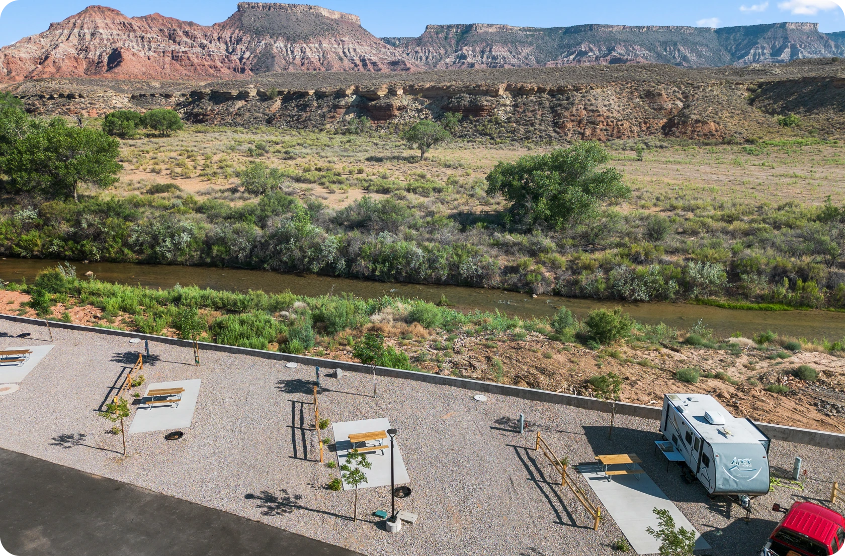 Desert campground with picnic tables and RV